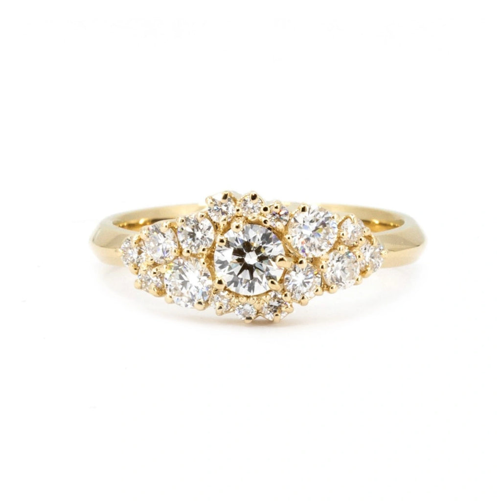 Front view of a yellow gold cluster ring set with 17 round brilliant diamonds (lab grown). This bridal piece of fine jewelry is seen photographed on a white background. It's handmade in Montreal, Canada, and available at Ruby Mardi.