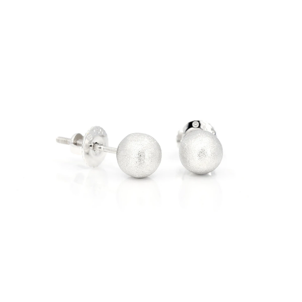 These pretty earrings are classic and timeless jewelry in the shape of small beads, made in white gold with a matte texture. The creators of the jewelry are the artisan jewelers VCL who made the studs by hand in Montreal. This fine piece of jewelry is available for sale at the Ruby Mardi jewelry store.