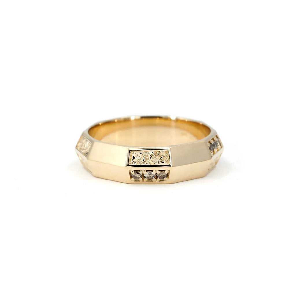 Designer wedding band with brown diamonds and a unique texture, seen photographed on a white background. 