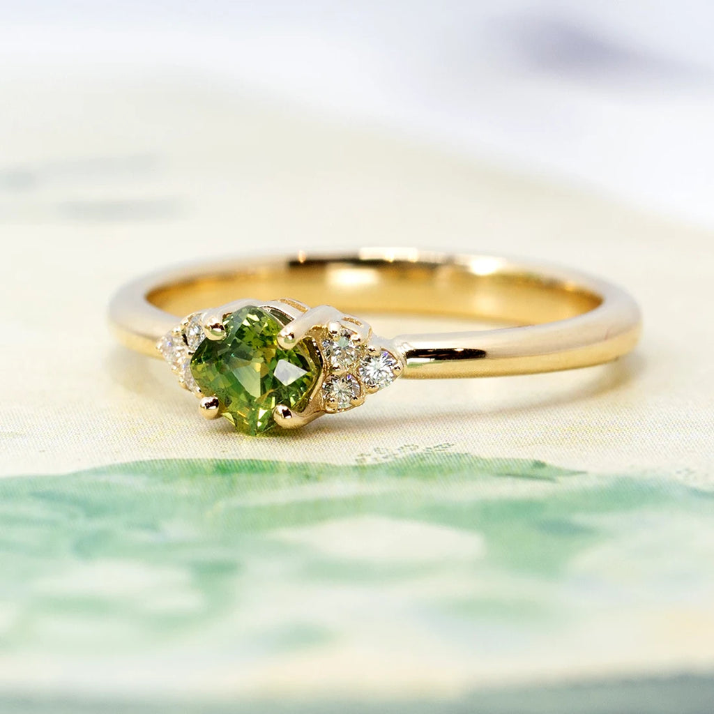Close up on a green sapphire engagement ring with natural diamond accents. Ruby Mardi sells Canadian independent jewelry brands and is the best alternative to Gem Breakfast in Canada. Best canadian jewelry.