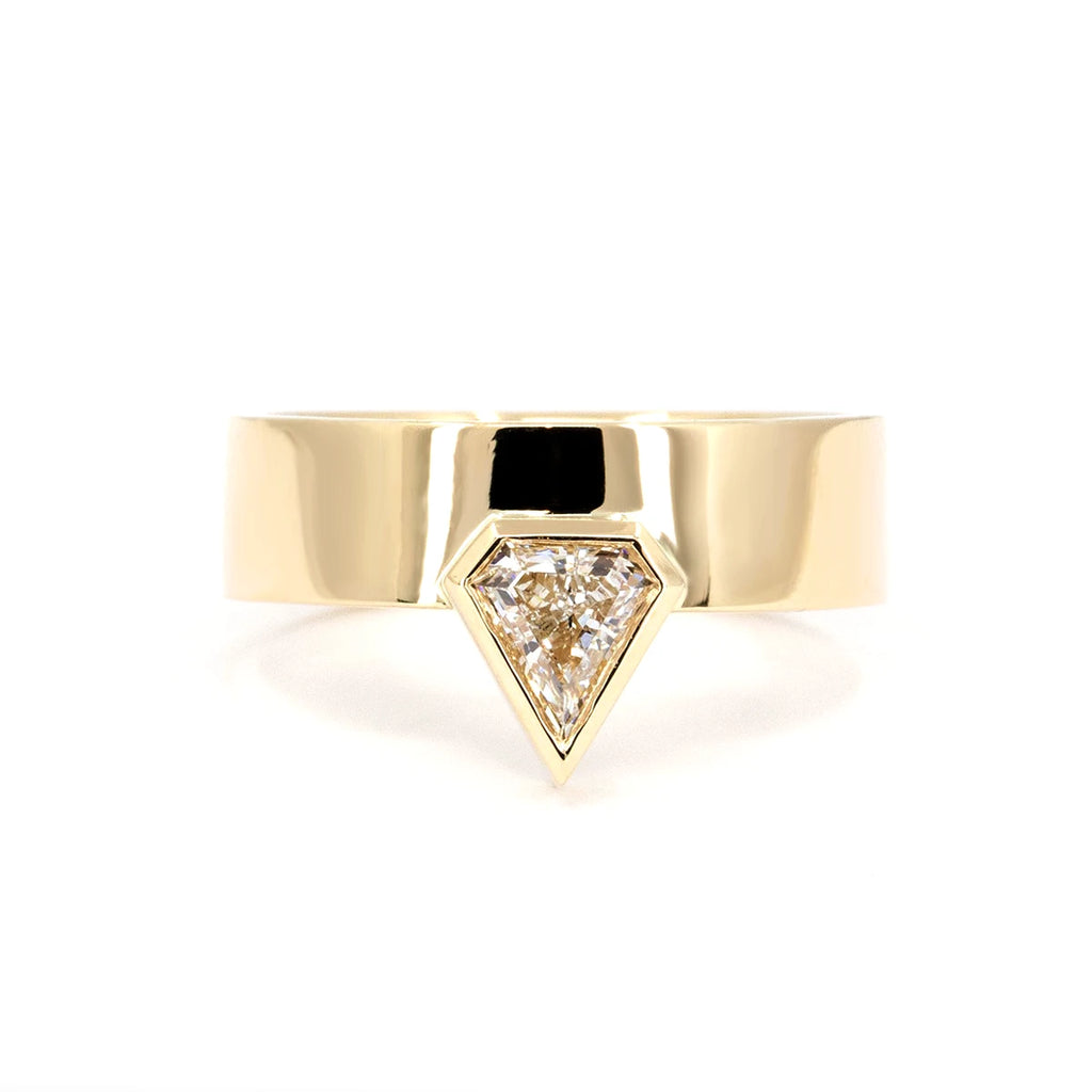 Bena Jewelry presents the boxy ring with a pentagonal diamond in a bezel setting and mounted on yellow gold. This diamond ring is a bold and unique creation of its kind, made in Canada by independent jewelry artisans. Available for sale at the Ruby Mardi jewelry store in Montreal in the Villeray and Rosemont district.