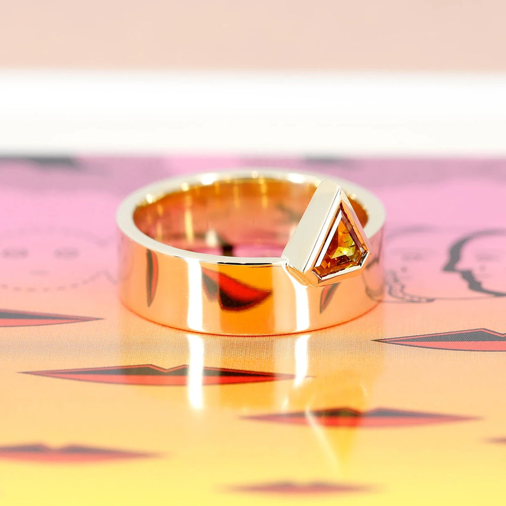 This splendid designer ring is made in yellow gold with a splendid orange colored diamond frome triangle. This ring is made by independent Canadian jeweler Bena Jewelry in collaboration with Ruby Mardi jewelry in Montreal, specialist in fine statement jewelry and alternative engagement rings.