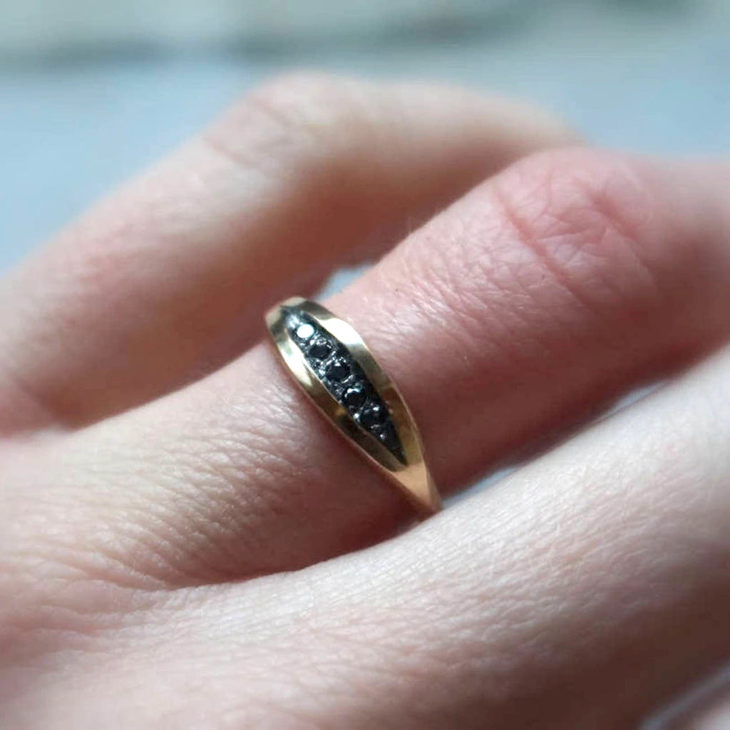 girl wearing a black diamond yellow gold ring custom made in montreal for boutique ruby mardi canadian jewellery gallery by Sheena Purcell