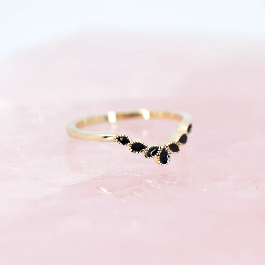 side view of black enamel yellow gold wedding band custom vintage look miligrain danity made by the best engagement ring store in montreal boutique ruby mardi on pink background