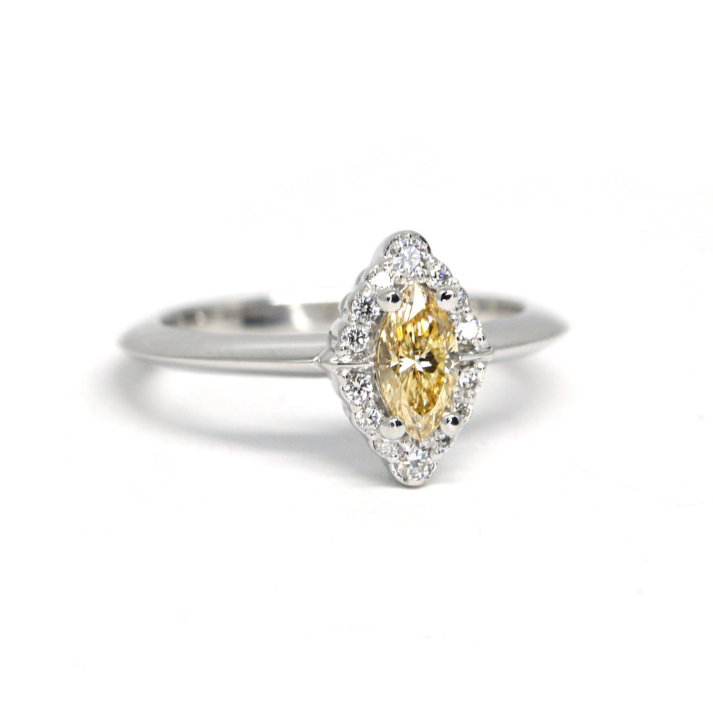 Engagement ring featuring a GIA certified yellow diamond and a halo of natural round brilliant diamonds. Find more high end jewelry pieces at our Montreal’s Little Italy store, along with the work of young talented Canadian designers. 