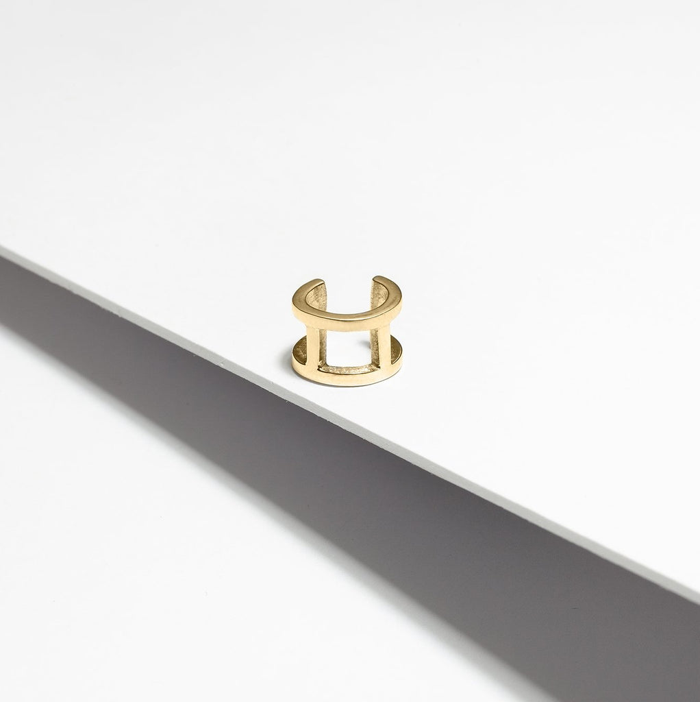 Double large ear cuff in gold plated handmade in Montreal by local jewelry brand Véronique Roy JWLS. Seen on a white background.