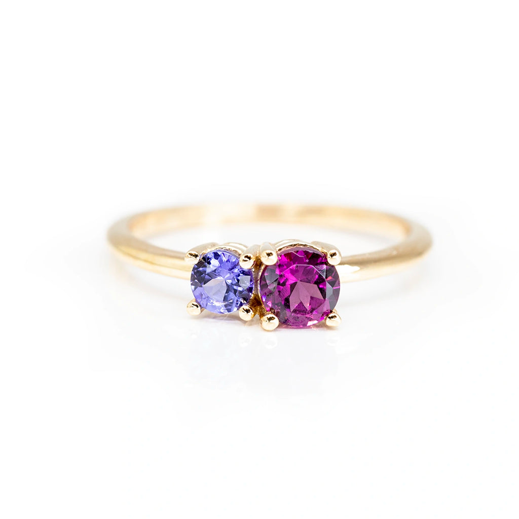 minimalist colored gemstone tanzanite and purple pink tourmaline round shape gems on a simple yellow gold band made in montreal by lico jewelry fine designer at the best jewellery store in montreal boutique ruby mardi on a white background