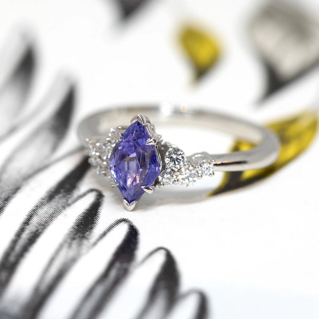 Platinum engagement ring with a stunning fancy shape tanzanite and round brilliant diamonds. One-of-a-kind feminine exquisite asymmetrical creation. Ruby Mardi is the only fine jewelry gallery in Montreal. We show the creations of the best Canadian jewelry designers. 