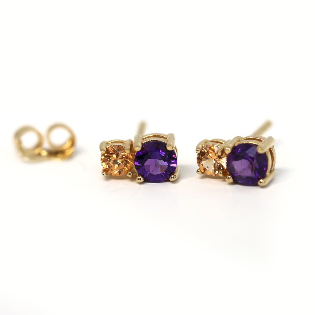 Gold gemstone stud earrings featuring tangerine garnet and amethyst, birthstones of January and February. Jewelry available at high end concept store and gallery Ruby Mardi.
