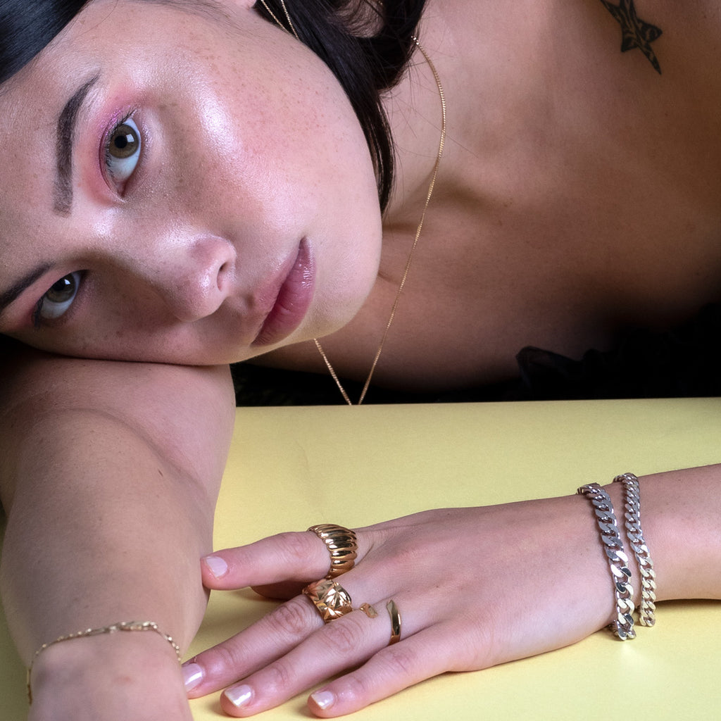 Curb chains of two different size worn by a young lady, with other statement jewelry handmade in Montreal. Available at jewelry store Ruby Mardi.