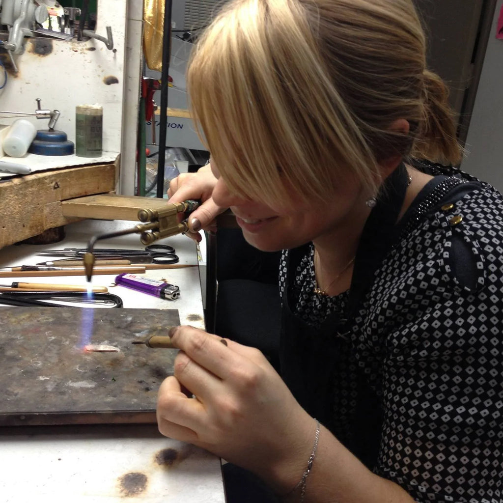 Canadian jewelry designer Emily Gill working at her bench. 