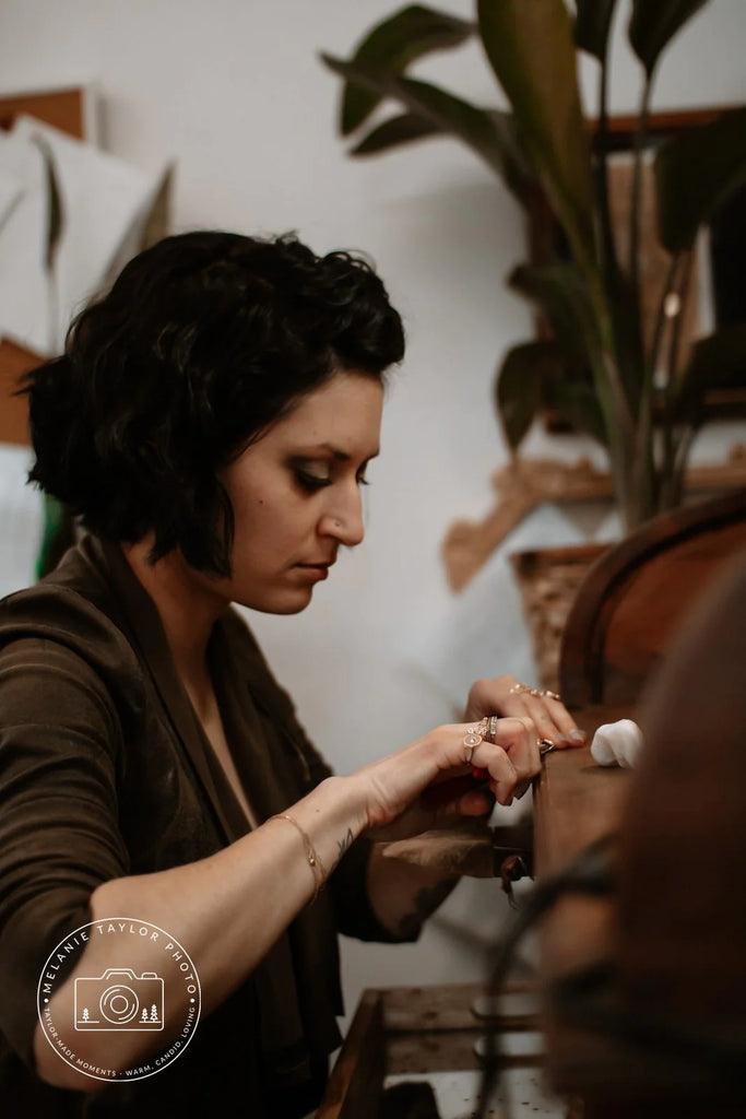 A young lady (Nadia Werchola) is working at creating fine jewelry. 
