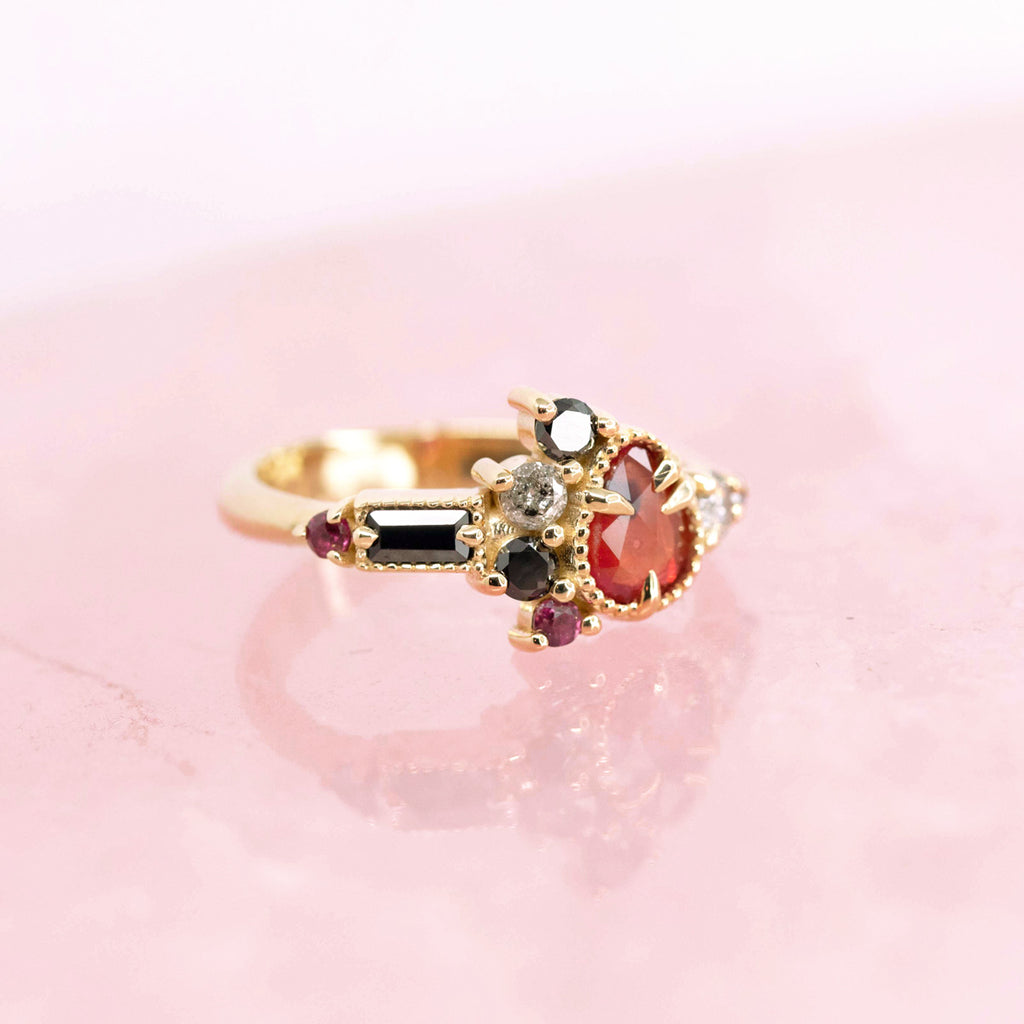 Gold ring with rubies, diamonds and black spinel by Nadia Werchola. One of a kind ring available in Montreal at fine jewelry store Ruby Mardi.