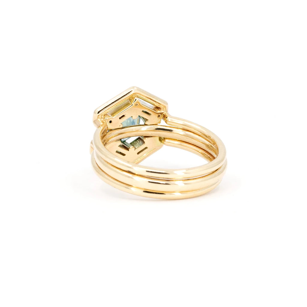 Back view of two gold rings that fits in one another, making a 2 in 1 design. It's photographed on a white background. It's a design from Erica Leal, an indie designer from Vancouver.