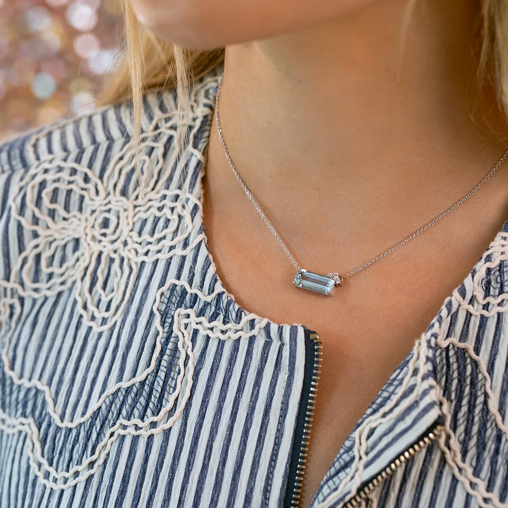 Close-up of a 14k white gold necklace featuring a 4-carat emerald-cut aquamarine and delicate diamond accents, handmade by designer Justine Quintal. Available exclusively at Ruby Mardi, Montreal’s coolest jewelry store.