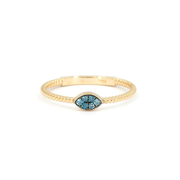 Alizé ring in 14k yellow gold with twisted band and marquise-shaped blue diamond pavé detail. Unique fine jewelry piece available at Ruby Mardi, Montreal.