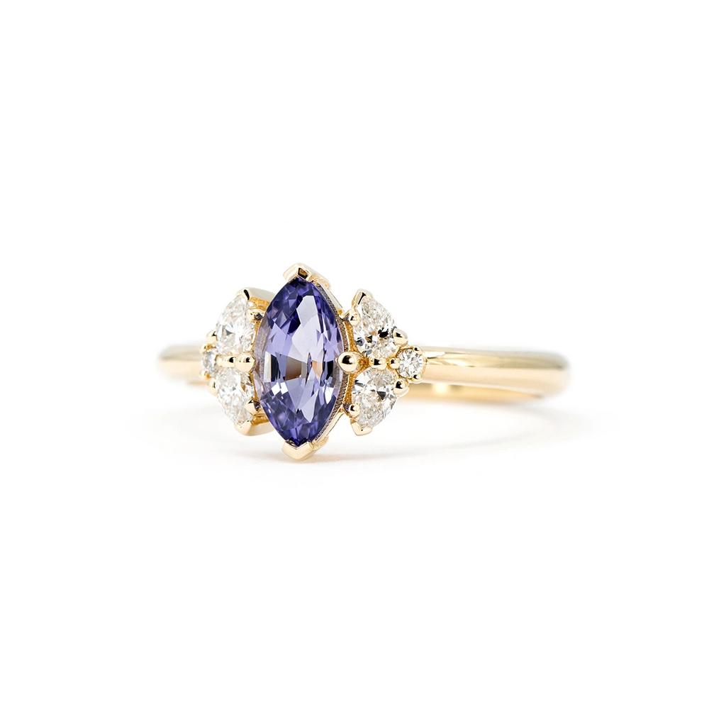 Front view of a marquise purple sapphire engagement ring with six accent diamonds in a floral arrangement.