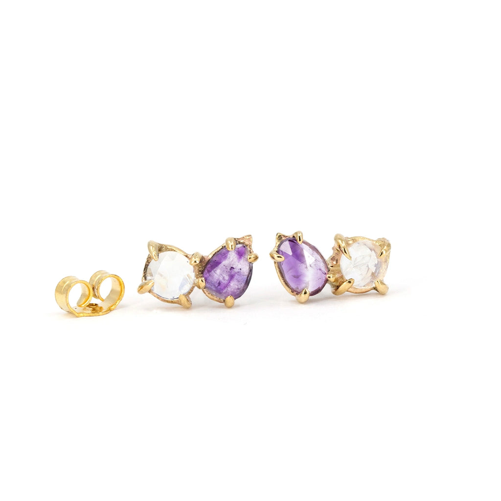 Pair of one-of-a-kind 10k yellow gold stud earrings by independent Toronto designer Nadia Werchola, featuring natural pear-shaped amethysts and round moonstones in organic prong settings, photographed on a white background, available at Ruby Mardi in Montreal.