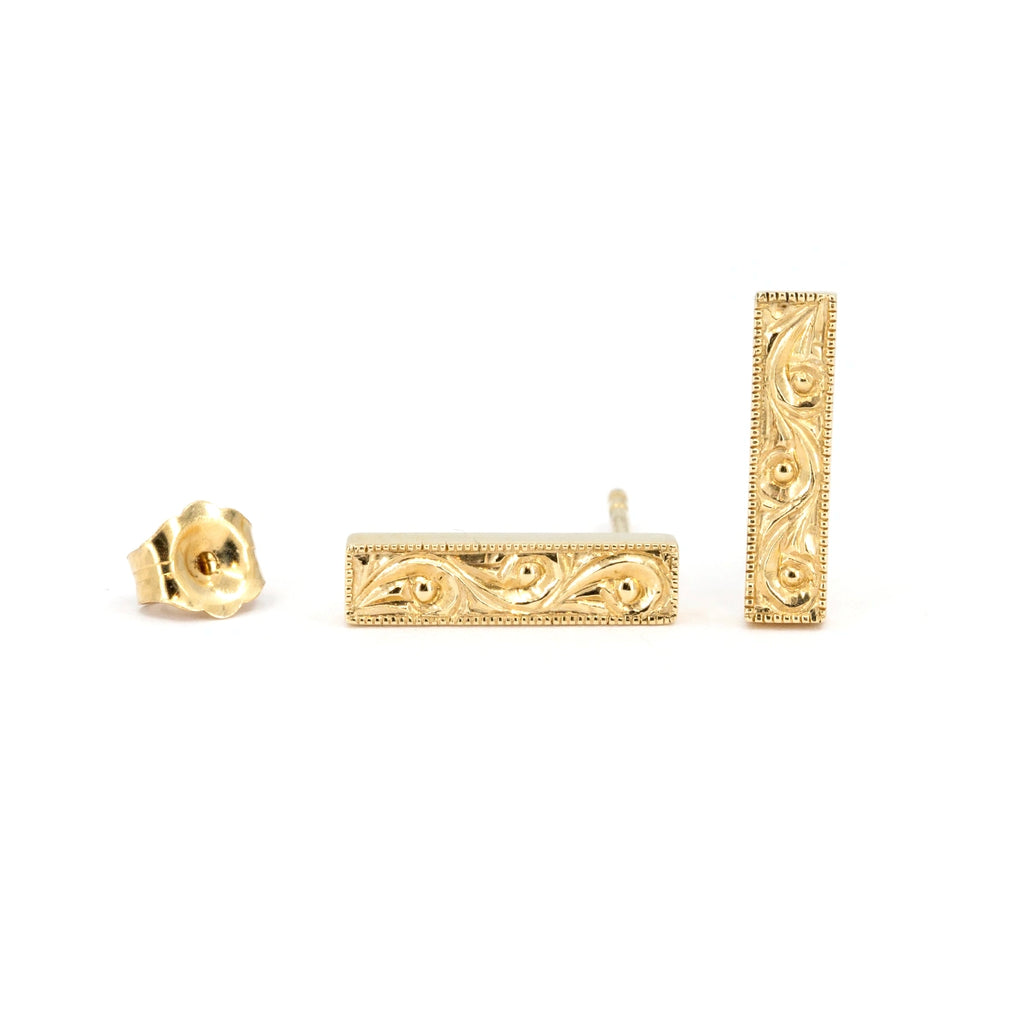 Pair of rectangular gold bar stud earrings with scrollwork engraving and milgrain border, handcrafted by Deborah Lavery for Ruby Mardi, photographed on white background.