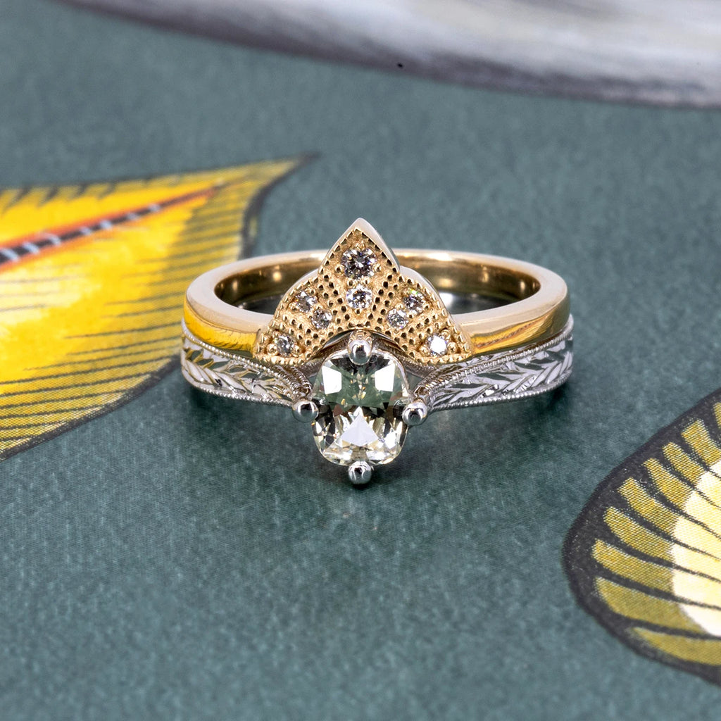 Art Deco-inspired engagement ring with pale yellow sapphire and engraved white gold band, paired with a yellow gold contour band set with white diamonds. Designed by Deborah Lavery, available at Ruby Mardi, Montreal.