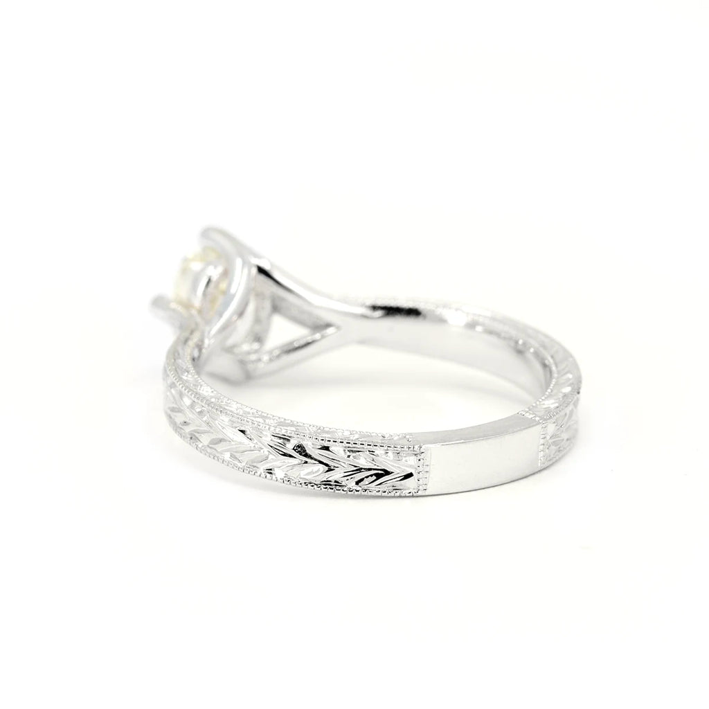 Back view of 14k white gold Art Deco-inspired engagement ring with pale yellow sapphire and hand-engraved leaf motif. Designed by Deborah Lavery, available at Ruby Mardi, Montreal.