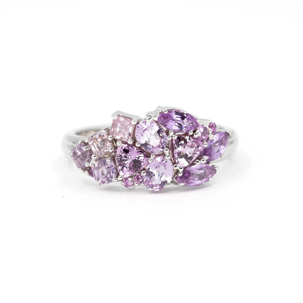 This splendid designer ring is made with a set of purplish pink sapphire of various shapes and mounted on white gold. This fine piece of jewelry is an original creation made by jewelry designer Ruby Mardi in Montreal. Made with natural gems, this exceptional piece of jewelry is made by passionate Canadian jewelers.