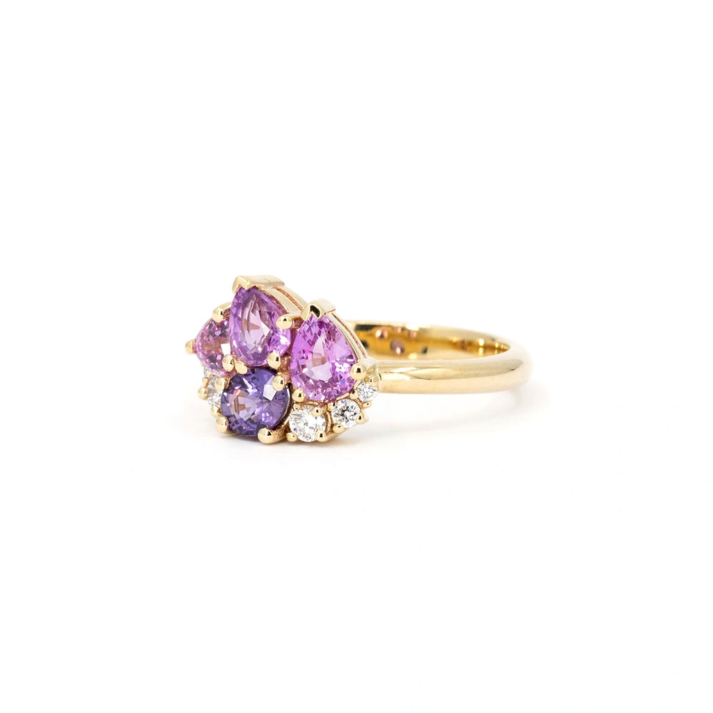 Side view of the Petal Soufflé ring by Ruby Mardi in Montreal. Unique cluster arrangement of natural lilac, purple and pink sapphires with lab-grown diamonds set in polished 14k yellow gold.