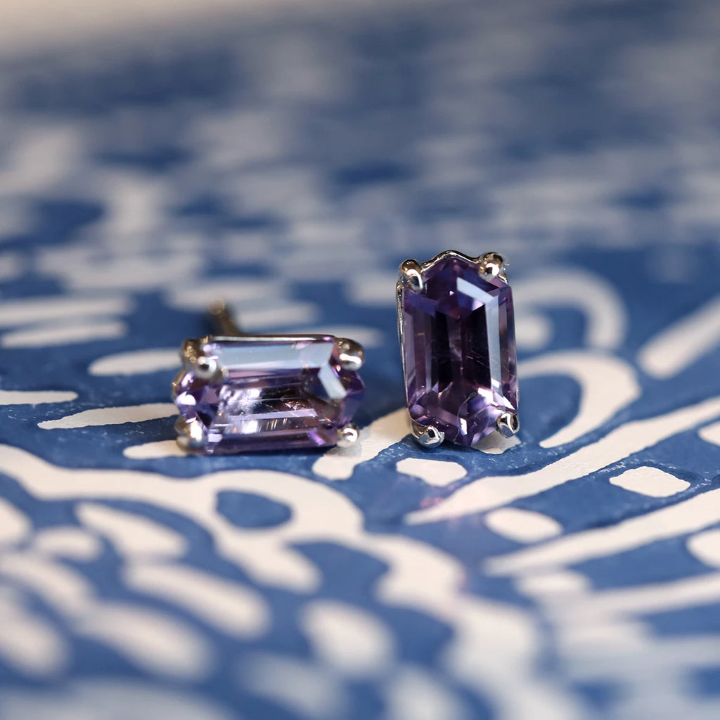 Amethyst baguette silver stud earrings handmade in Montreal photographed on a white & blue artistic background.