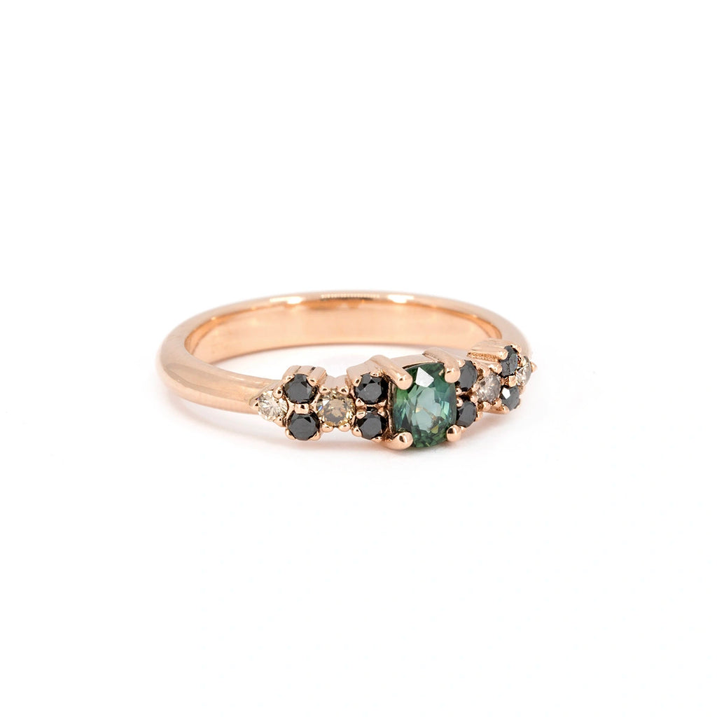Teal sapphire and black diamond ring in rose gold on white background. Fine jewelry designed by Ruby Mardi in Montreal, part of the Bloom Line collection.