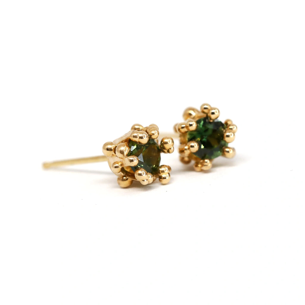 14k yellow gold earrings with green Montana sapphires and hand-applied gold granules, designed by Meg Lizabet. Artisanally crafted in Canada, these unique organic earrings are available at Ruby Mardi, a fine jewelry gallery in Montreal's Little Italy.
