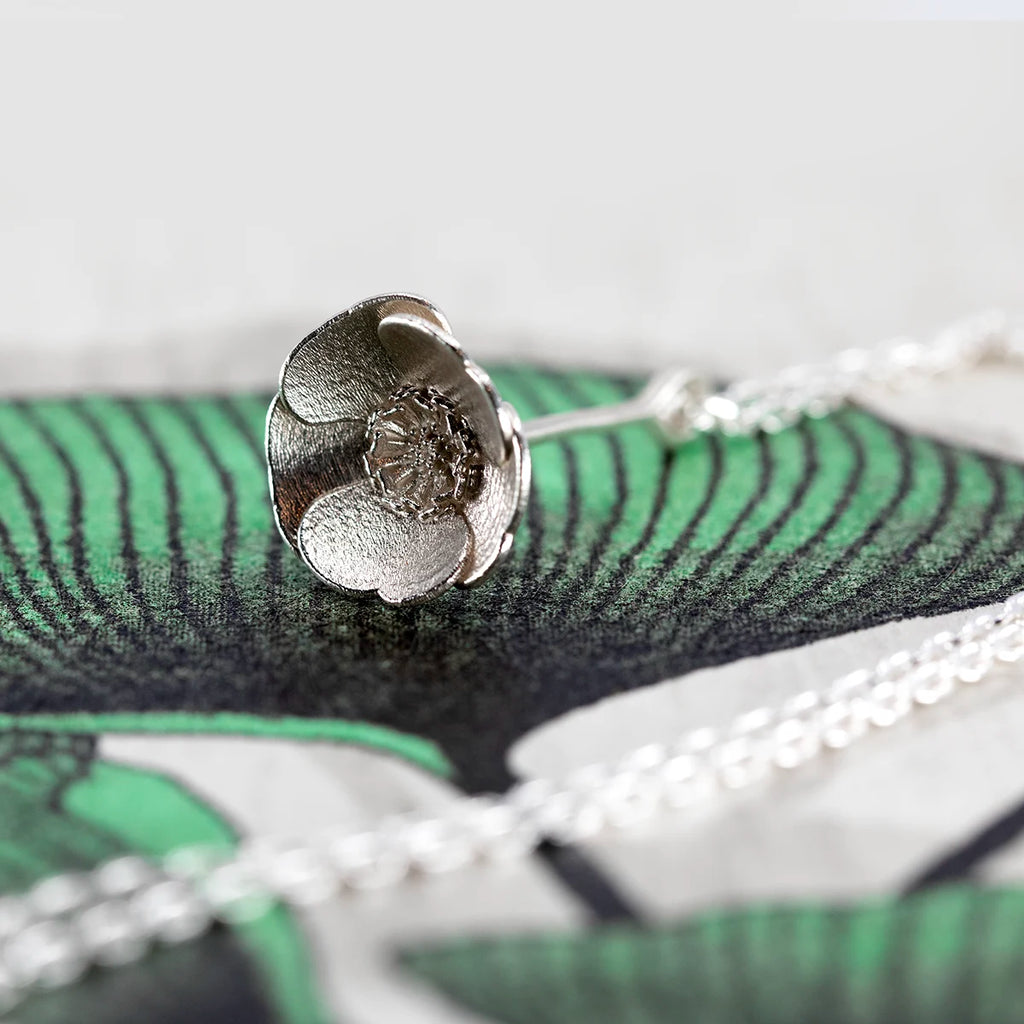 White gold buttercup flower pendant with detailed petals and center, crafted by Fleurs Sauvages Qc. Independent botanical jewelry available at Ruby Mardi Montreal.