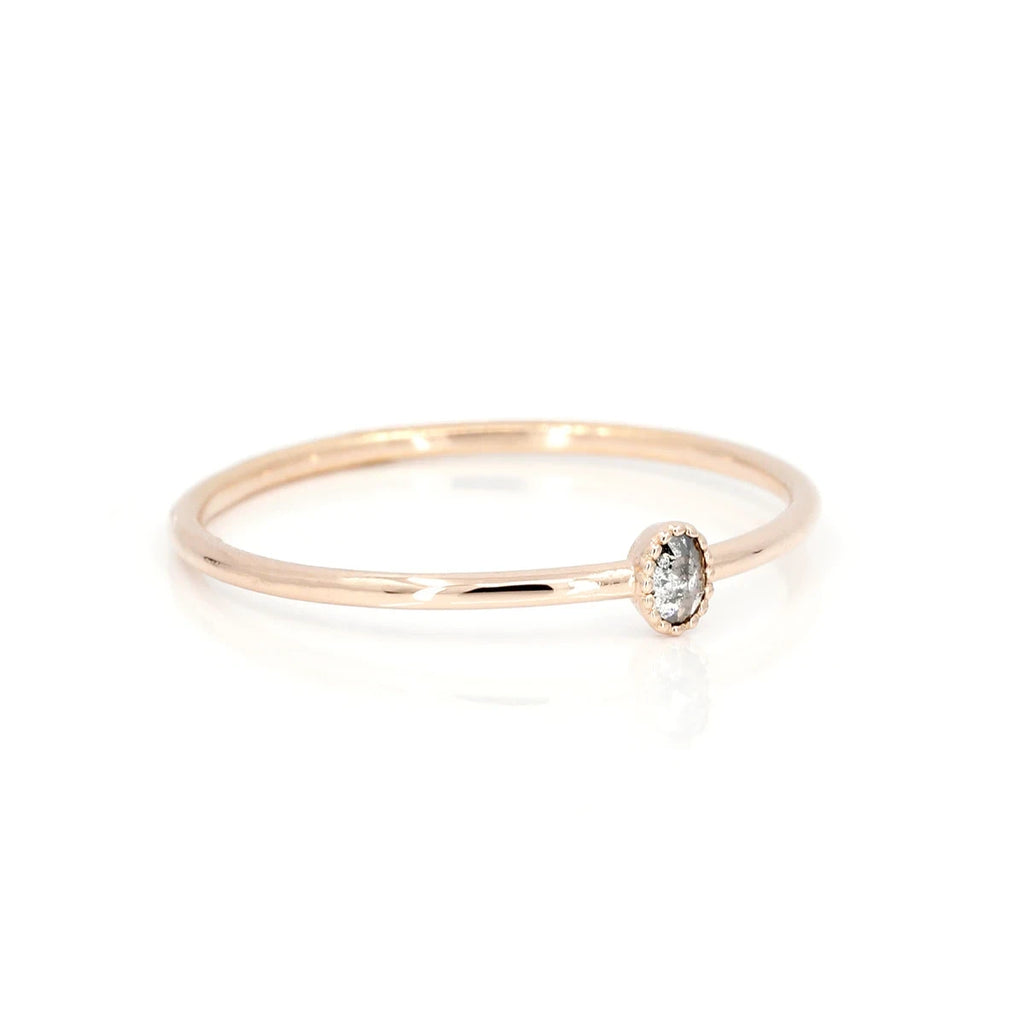 This rose gold engagement ring is set with an oval-shaped rose cut pepper diamond. The bridal ring is the Manon model by jewelry designer Émigé from Montreal and available for sale at the Ruby Mardis jewelry store, specialist in alternative bridal jewelry.