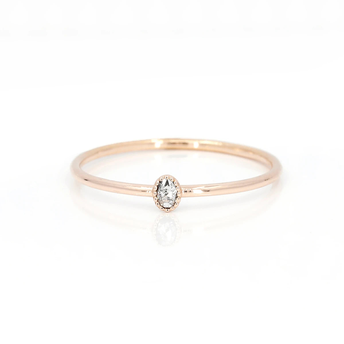 Delicate ring from independent jewelry designer Émigé from Montreal. This small wedding ring is made in gold with a salt and pepper diamond cut in rose cut and bezel set with a delicate miligrain. This splendid engagement ring is available for sale in Montreal at the Ruby Mardi jewelry store.
