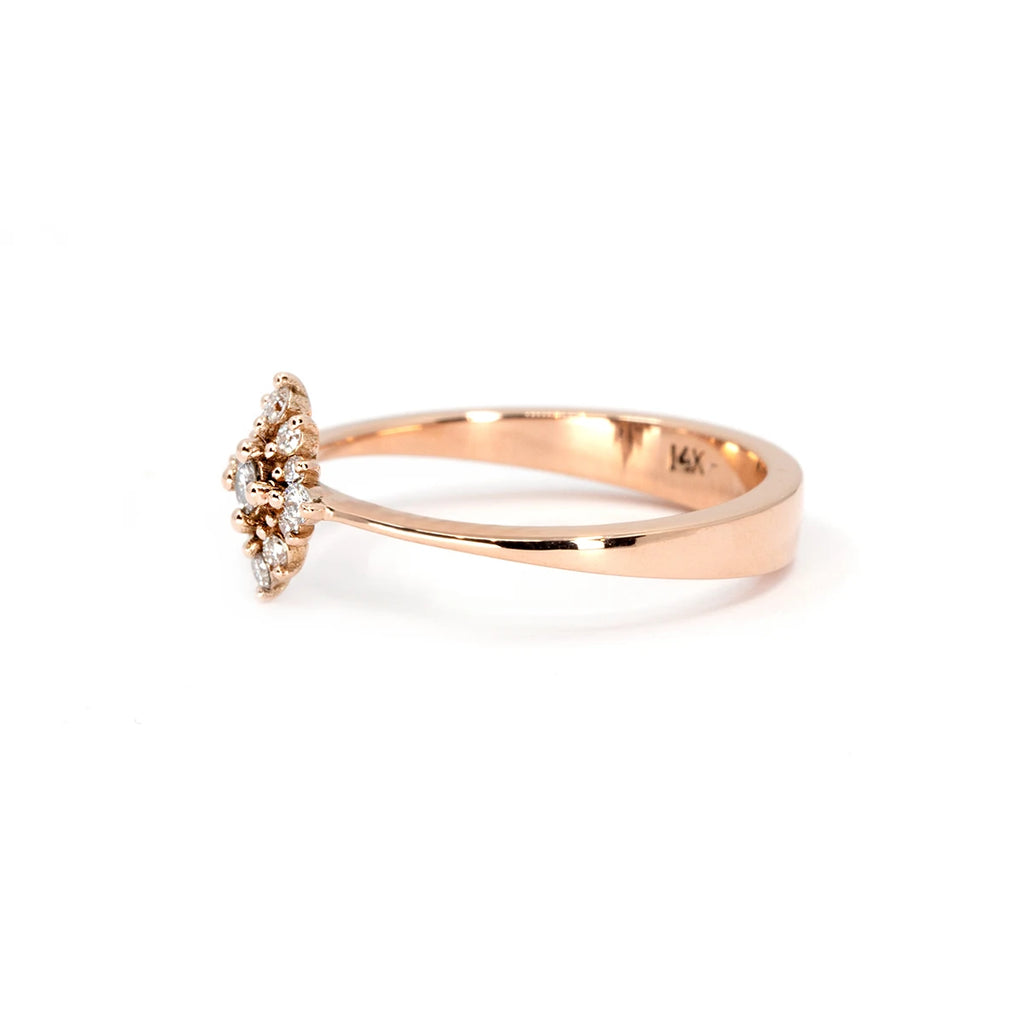 Side view of the Solstice ring, a 14k rose gold design featuring a delicate diamond cluster. The elegant, slightly elevated setting allows light to enhance the brilliance of each diamond. Available at Ruby Mardi, an independent jewelry boutique in Montreal offering custom creations.