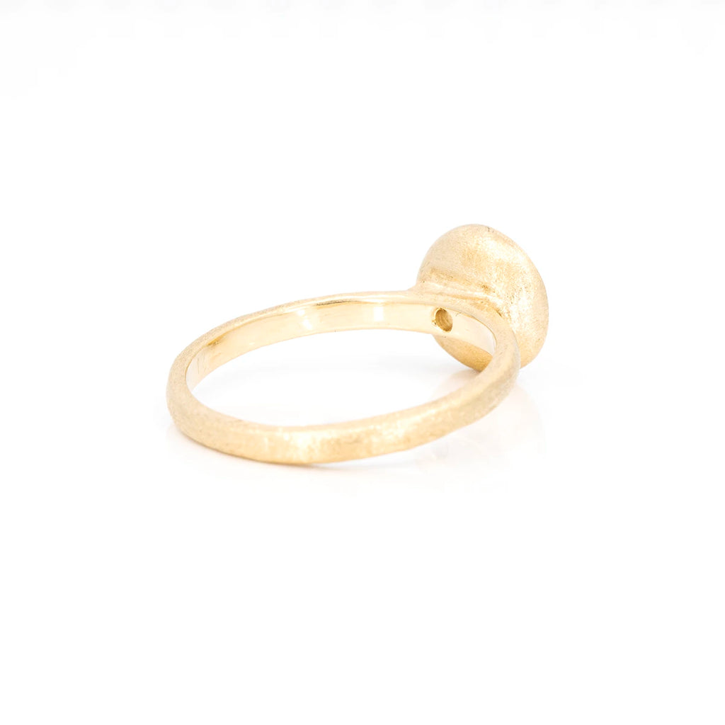 Back view of an organic yellow gold handmade ring photographed on a white background.