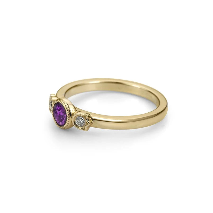 Bramston Goldsmithing, an independent Canadian jewelry designer, presents the Chloé ring with a splendid deep purple sapphire, a natural gem in a rectangular shape and surrounded by two small round diamonds. Bezel-set with a delightful miligrain, this one-of-a-kind ring is made in Canada and available for sale in Montreal at the Ruby Mardi jewelry store