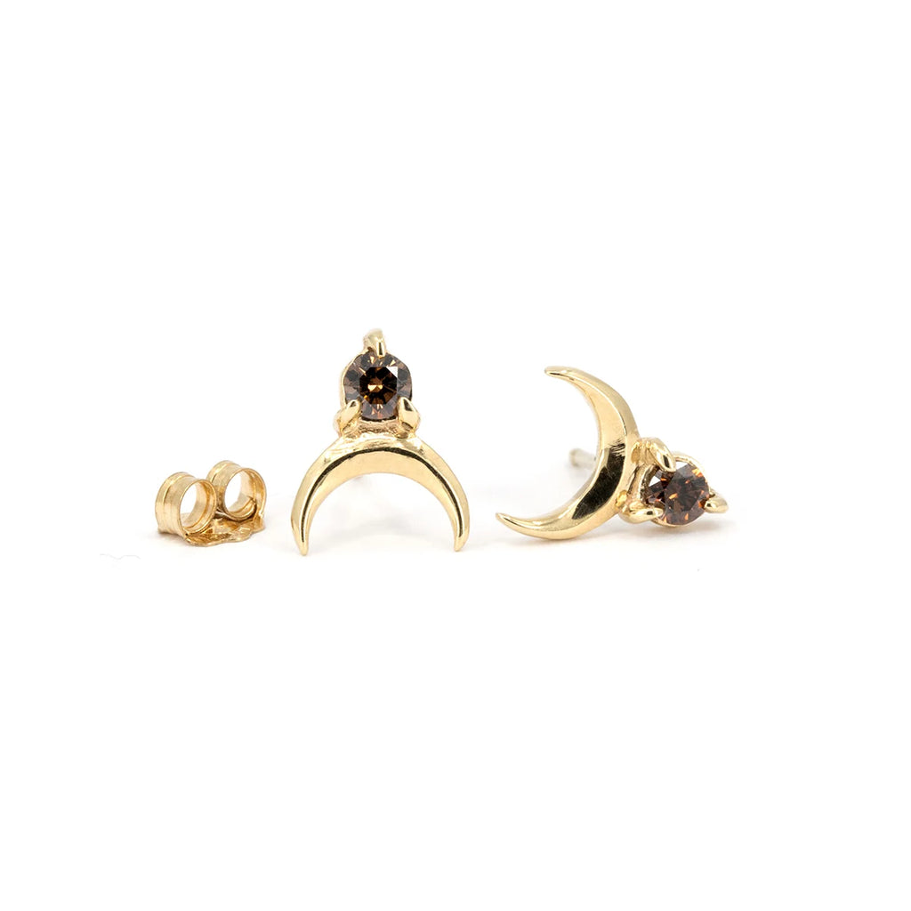 Pair of 10k gold crescent-moon stud earrings with natural chocolate diamonds by Nadia Werchola, displayed on a white background, Ruby Mardi Montreal.