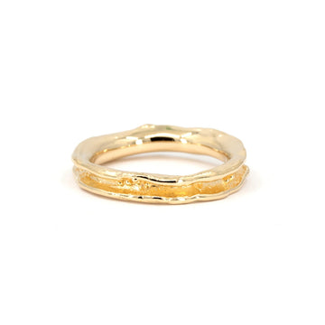 Handmade concave gold wedding band with organic texture and molten bubble detail, designed by Meg Lizabet and available exclusively at Ruby Mardi in Montreal.