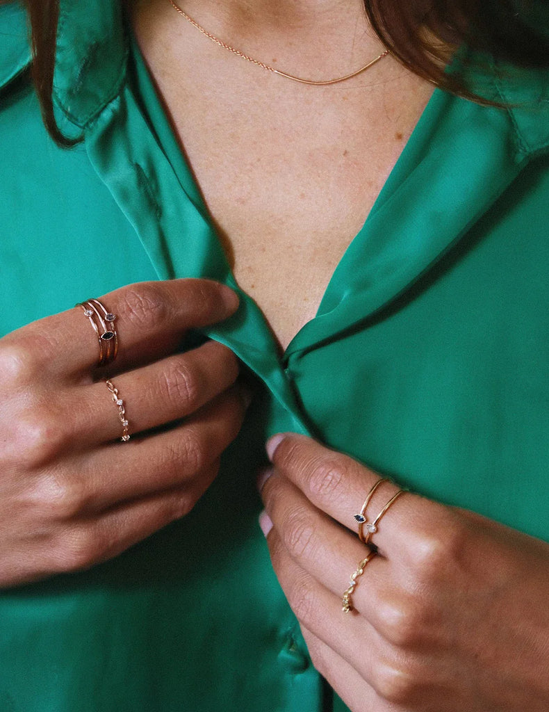 Young woman wearing a set of independent Canadian and Quebec jewelry designer rings represented by the Ruby Mardi jewelry store located in Montreal's Little Italy and specializing in bridal and statement jewelry.