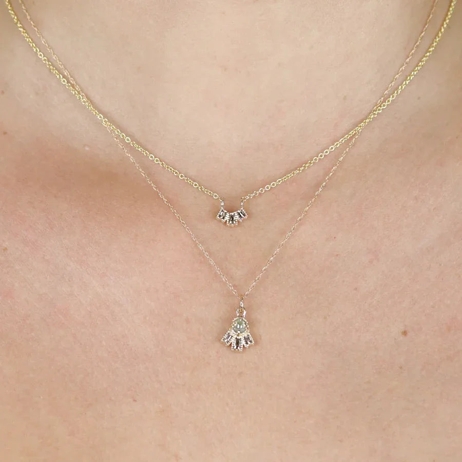 A close up on 2 yellow gold diamond pendants handmade and designed in Toronto by independent designer Nadia Werchola. Both diamond necklaces are available at best jewelry store in Canada: Ruby Mardi.