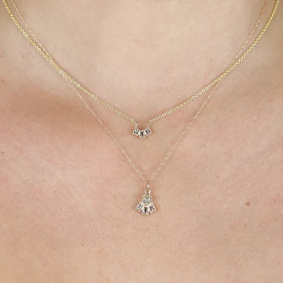 A close up on 2 yellow gold diamond pendants handmade and designed in Toronto by independent designer Nadia Werchola. Both diamond necklaces are available at best jewelry store in Canada: Ruby Mardi.