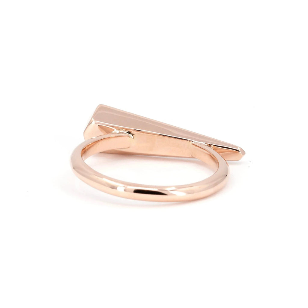 Back view of a rose gold modern ring with small vivid pink sapphires designed and handmade in Montreal, seen on a white background.
