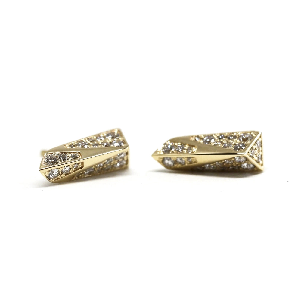 Slick and modern diamond stud earrings photographed on a white background. These edgy yellow gold earrings are a creation of high end Canadian brand Bena Jewelry.