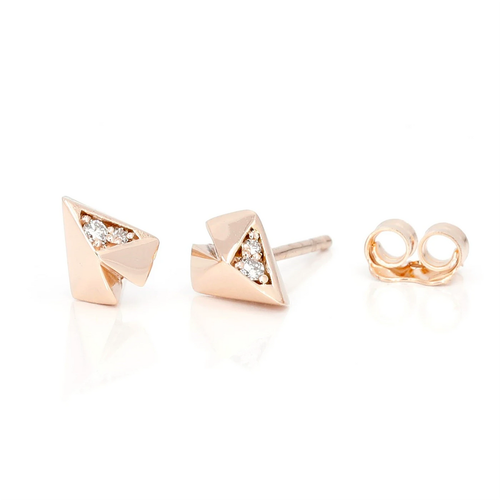 Rose gold stud earrings with 4 natural diamonds. The jewelry piece is photographed on a white background. These edgy gender neutral studs were designed by local brand Bena Jewelry and are available online with worldwide shipping.