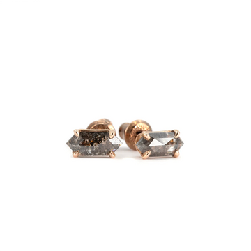 Pair of geometric salt and pepper diamond stud earrings in rose gold by Emily Gill. Modern fine jewelry photographed on a bright white background for Ruby Mardi, Montreal.