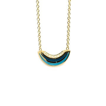 A 14k yellow gold necklace with blue and black enamel and diamond accents by Canadian designer Emily Gill, available at Ruby Mardi fine jewelry boutique in Montreal.