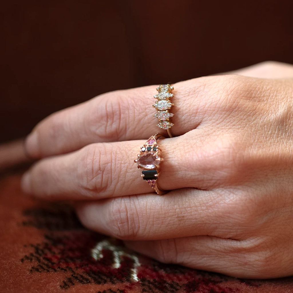 Hand wearing a diamond ring by Nadia Werchola, featuring round lab-created diamonds set in 10k yellow gold. The piece sits on the finger with a soft sparkle, photographed against a warm woven fabric for a natural, intimate feel.