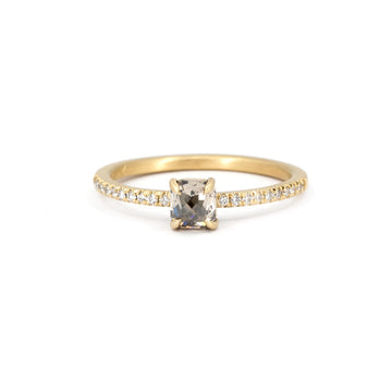 Classic solitaire engagement ring with semi-eternity round diamonds on the band and a cushion champagne center diamond. This delicate, romantic piece of jewelry was created in Ottawa, Canada, by independent brand Fluid Jewellery, from ethical Fairmined-certified gold. The jewel is shown against a white background. This wedding ring is available at Ruby Mardi, Canada's coolest jewelry store.