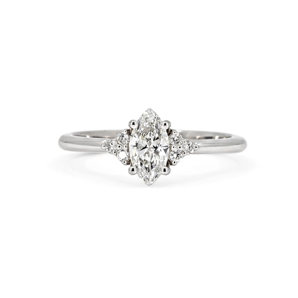 Lab grown marquise diamond engagement ring with diamond accents, set in 14k white gold and photographed on a white background. This classic piece of jewelry was designed and handcrafted in Montreal, by local and independent brand Ruby Mardi.