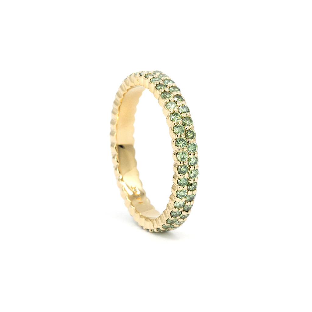 Green diamond double-row eternity ring in solid 14k yellow gold, photographed flat to highlight the clean pavé rows and refined craftsmanship. Fine jewelry available at Ruby Mardi Montréal.